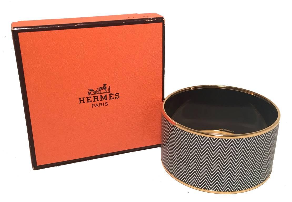 BEAUTIFUL HERMES Large enamel bangle bracelet in excellent condition.  Black and White zig zag print with gold detailing and black enamel backing.  Thickest bangle style available. Stamped Hermes, made in France 