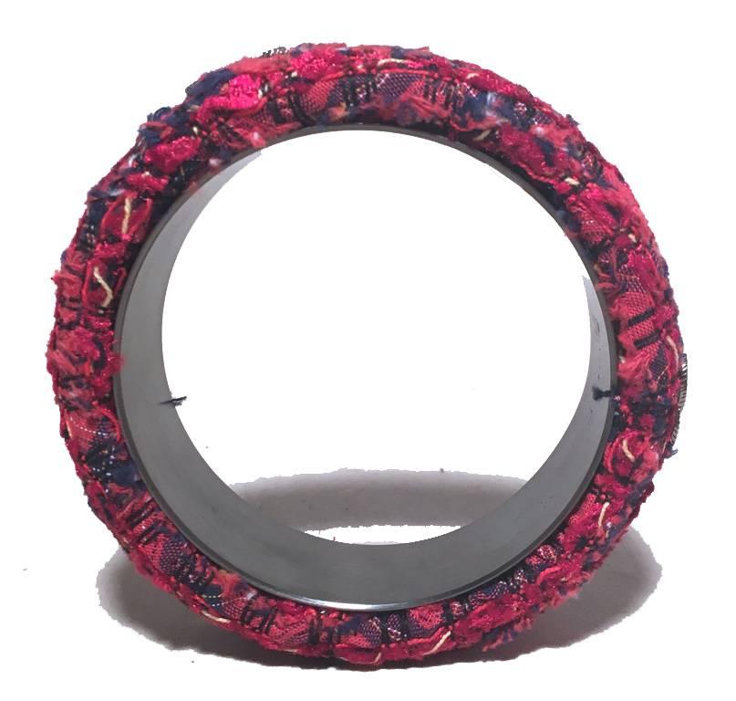 RARE CHANEL tweed and steel bangle bracelet in excellent condition.  Woven red tweed with steel backing and CC chanel logo emblems throughout.  Stamped 