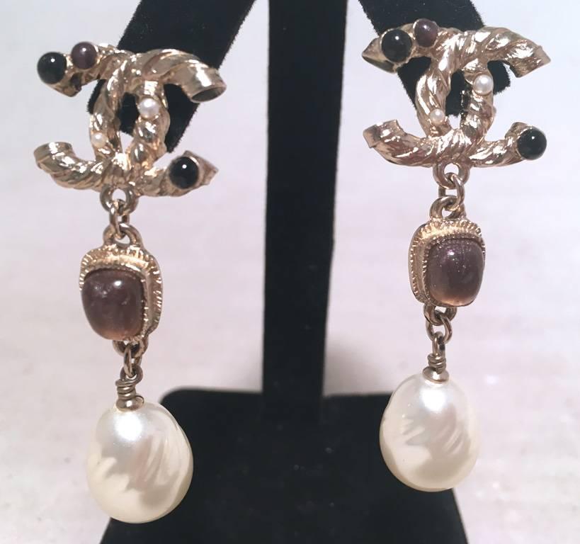 RARE CHANEL Silver dangle earrings in excellent condition.  Silver CC logo trimmed with onyx and amethyst tiny gemstones.  Next tier down features purple amethyst stones set in silver hardware and ends with genuine teardrop 1/2