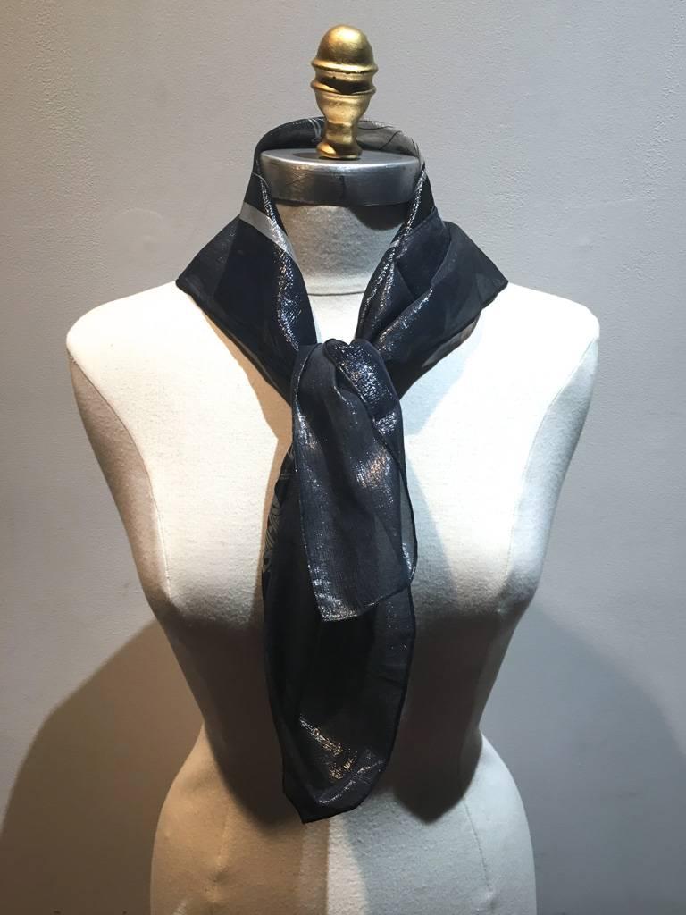 Hermes navy blue silk and lurex woven scarf in excellent condition.  Sheer navy blue silk woven with shimmery silver lurex in a classic Hermes print design.  made in France. original tag attached. Signed Hermes.  Would make a wonderful gift for the