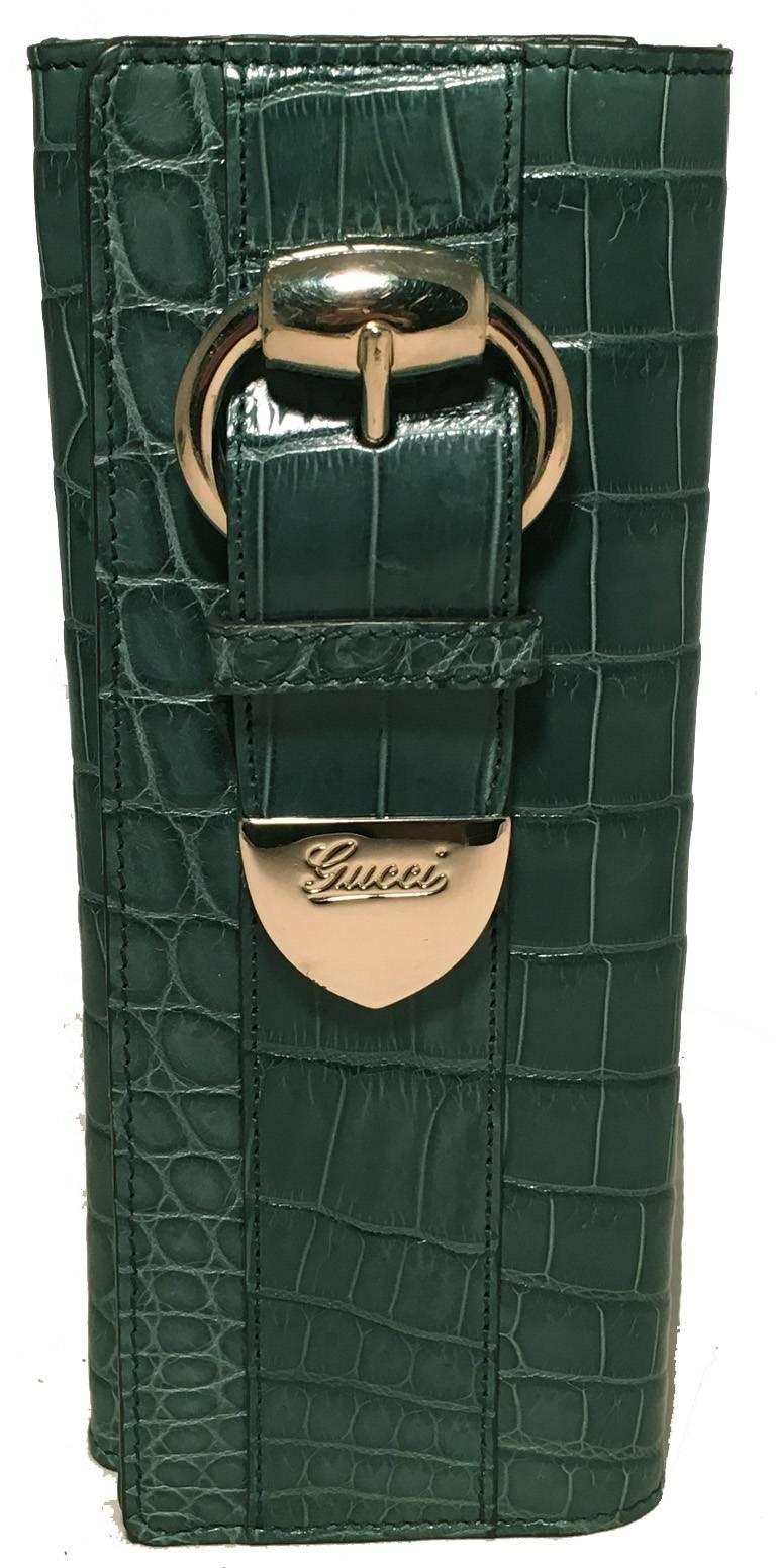 GORGEOUS GUCCI green alligator wallet clutch in excellent condition.  Green alligator leather exterior trimmed with golden hardware.  Front snap flap closure opens to a green leather lined interior with just enough space for your essentials. 