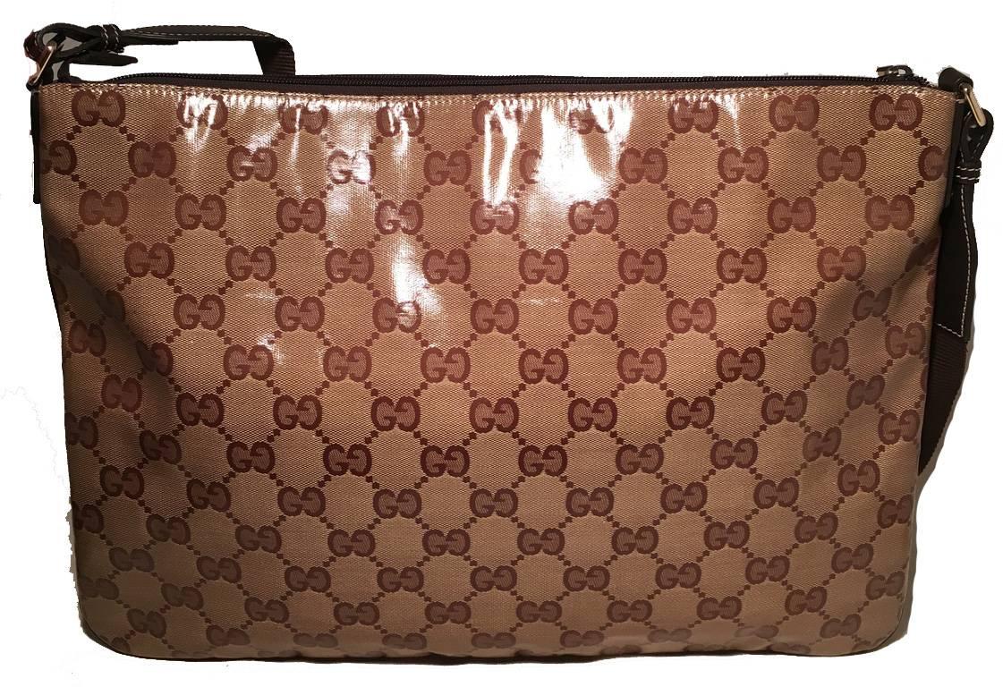 Timeless Gucci monogram messenger bag in excellent condition.  Coated monogram canvas exterior trimmed with brown leather and woven adjustable shoulder strap.  Top zipper closure opens to a brown nylon interior that holds ample storage space for