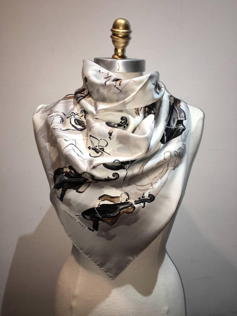 Gorgeous Vintage Hermes Concerto silk scarf in excellent condition.  Original silk screen design c1963 by 	Jean-Louis Clerc features an artistic rendering of a musical orchestra over a light grey / cream background.  100% silk, hand rolled hem. made