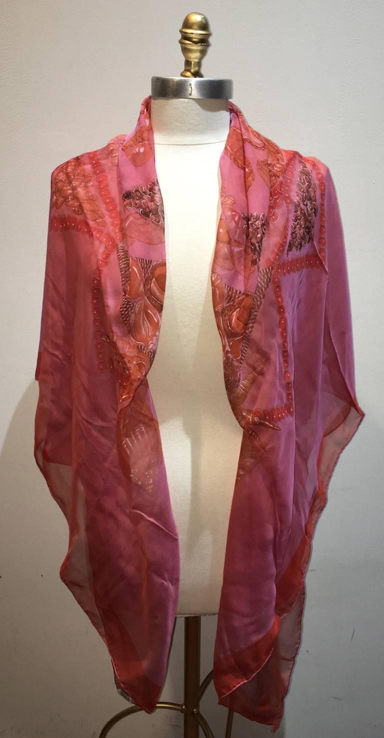 STUNNING Hermes sheer Rocaille silk shawl scarf in excellent condition.  Original silk screen design c1999 by Valerie Dawlat-Dumoulin features an assortment of sea shells over a pink sheer background surrounded by a red border.  100% silk, hand