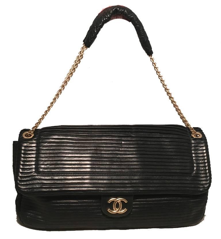 STUNNING Chanel black leather classic flap shoulder bag in excellent condition.  Pleated black leather upon top flap with diamond quilted leather throughout. gold chain shoulder strap and leather shoulder protector.  Snap front Logo closure opens to