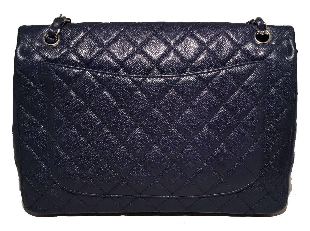 GORGEOUS Chanel navy blue quilted caviar Maxi classic flap shoulder bag in excellent condition.  Diamond quilted navy blue caviar leather exterior trimmed with shining silver hardware.  woven chain and leather shoulder strap can be worn long or