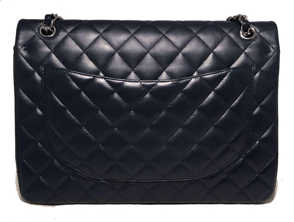 Stunning Chanel navy 2.55 double flap classic maxi shoulder bag in excellent condition.  Quilted navy blue lambskin leather exterior trimmed with sparkling silver hardware.  woven chain and leather shoulder strap can be worn short or long. Front CC