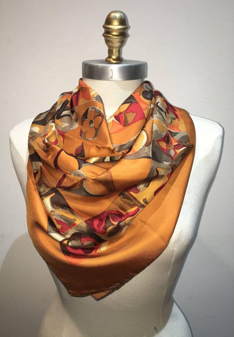 Gorgeous Louis Vuitton silk square scarf in excellent condition.  Goldenrod background with multi color painted monogram design print throughout.  Rolled hem, 100% silk, made in France. Measures 35"x35". Signed with Louis Vuitton