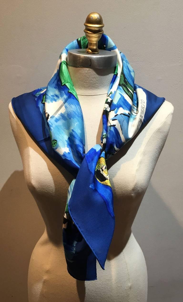 GORGEOUS Hermes Concerto scarf in blue in excellent condition.  Original silk screen design c1962 by Jean-Louis Clerc features a water color painting of a musical orchestra in various blues and greens surrounded by a blue border.  100% silk, hand