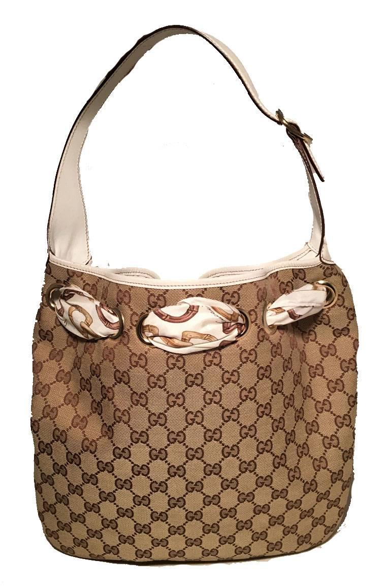 Beautiful Gucci monogram canvas and silk scarf shoulder bag in very good condition.  Monogram canvas exterior trimmed with white leather and white silk scarf woven through the top grommets and tied in a bow.  Beige linen lined interior with 1