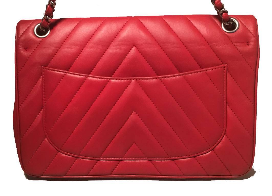 GORGEOUS Chanel red leather lions head classic flap in excellent condition.  Red lambskin leather exterior quilted in a chevron pattern trimmed with matte silver hardware and woven chain and leather shoulder strap.  Front Lions head twist closure