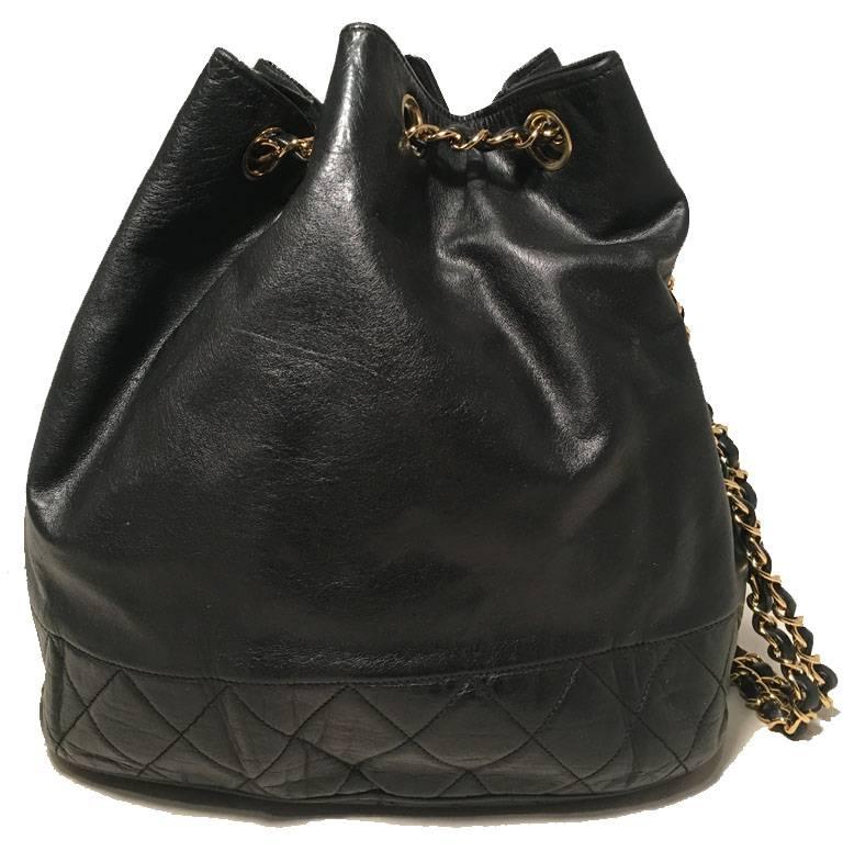 BEAUTIFUL Chanel black leather drawstring bucket bag in very good vintage condition.  Black lambskin leather with quilted leather bottom trimmed with gold woven chain and leather double shoulder strap and drawstring style closure. Fully lined black