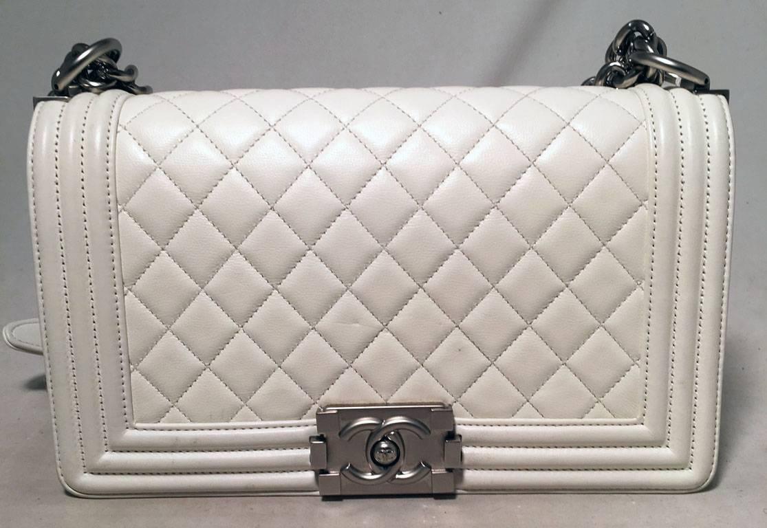 GORGEOUS Chanel White leather Le Boy bag in excellent condition.  White lambskin leather exterior trimmed with gunmetal hardware.  Heavy chain and leather shoulder strap can be worn short or long to suit any style.  Front pinch latch logo closure