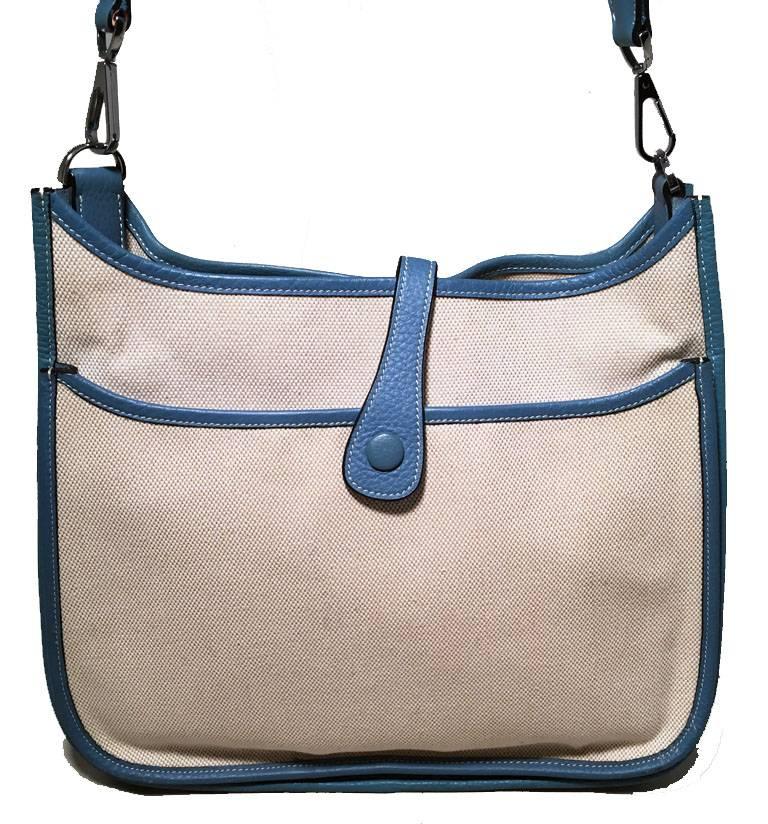 Beautiful Hermes Evelyne II PM in excellent condition.  Beige woven toile canvas body trimmed with blue jean clemence leather and silver palladium hardware.  Woven blue canvas shoulder strap is not adjustable but long enough to wear as a shoulder