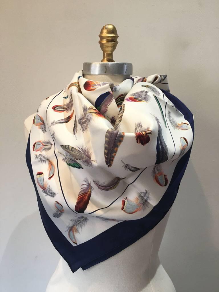 BEAUTIFUL Hermes vintage Plumes silk scarf in excellent condition.  Original silk screen design c1953 by Henri de Linares features various multicolor beautiful bird feathers over a white background surrounded by a navy blue border.  100% silk, hand