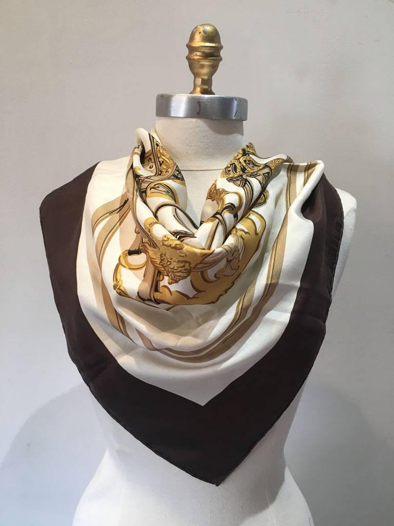 GORGEOUS Vintage Hermes Brides de Gala silk scarf in excellent condition.  Original silk screen design c1957 by Hugo Grygkar features equestrian horse stirrup dressings over a white background surrounded by a brown border. One of the most popular