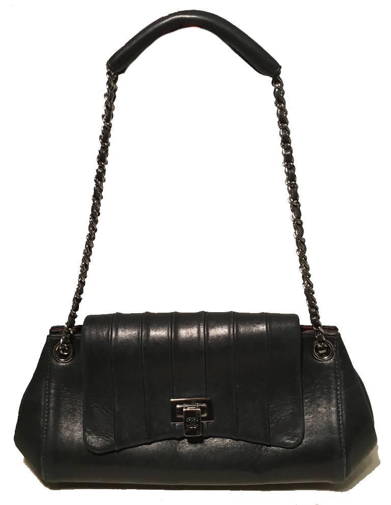 Chanel Mademoiselle Ligne Striped Top Flap Classic Shoulder Bag in excellent condition.  Black lambskin leather exterior trimmed with silver hardware and woven chain and leather double shoulder strap with padded leather shoulder.  Stripe pleated