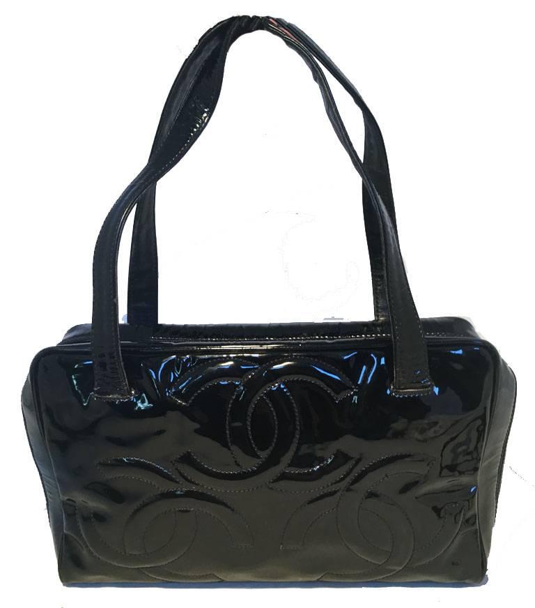 STUNNING Chanel black patent leather cc logo quilted handbag in very good condition.  Black patent leather exterior with quilted CC logo throughout trimmed with double top handles.  Double zipper closure opens to a black nylon lined interior that