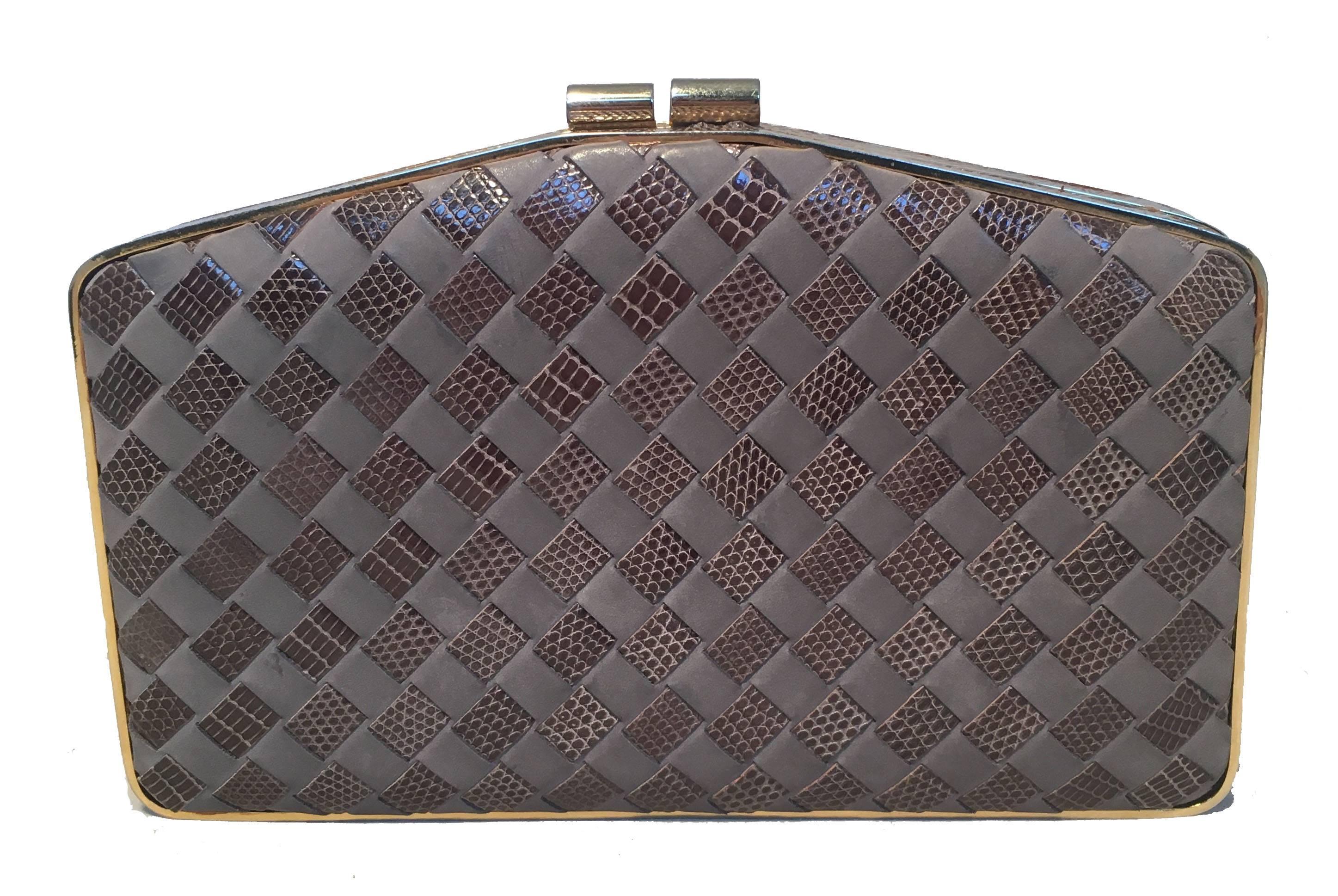 AMAZING Vintage Bottega Veneta lizard and leather woven clutch in very good condition.  Signature woven pattern designed exterior with lizard skin and grey leather trimmed with gold hardware. Top kiss lock style closure opens to a grey silk lined