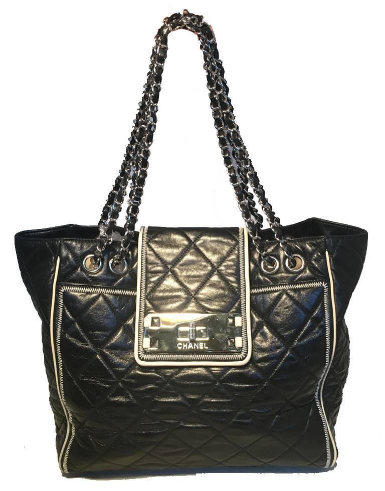 GORGEOUS CHANEL black and cream leather shoulder bag tote in excellent condition.  Black quilted leather exterior trimmed with silver hardware and cream leather piping throughout.  Double woven chain and leather shoulder straps.  Front twist