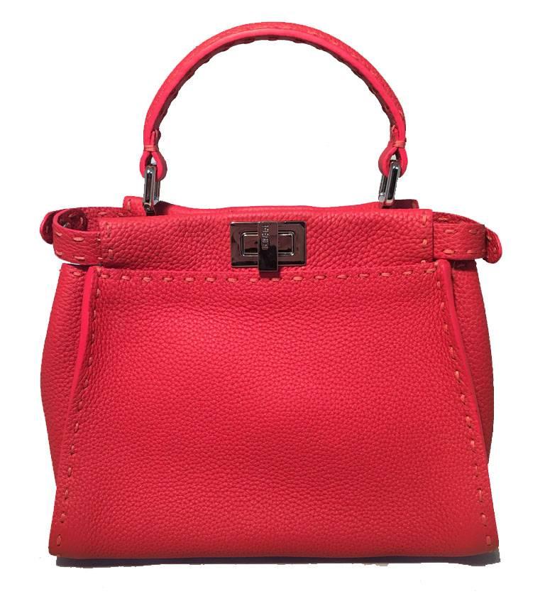 GORGEOUS Fendi red leather small peekaboo bag in excellent condition. Red leather exterior with red topstitching and silver hardware. Removable and adjustable shoulder strap included. Top double twist closures open to a grey leather lined interior