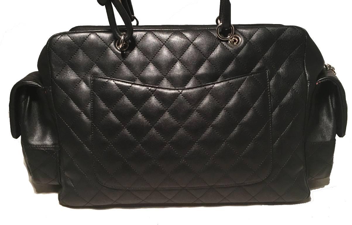 AMAZING Chanel black and white Rue Cambon Reporter bag in excellent condition.  Quilted black leather exterior trimmed with white leather CC chanel logo along front side.  4 exterior flap pockets with twist cc logo closures. Backside exterior slit