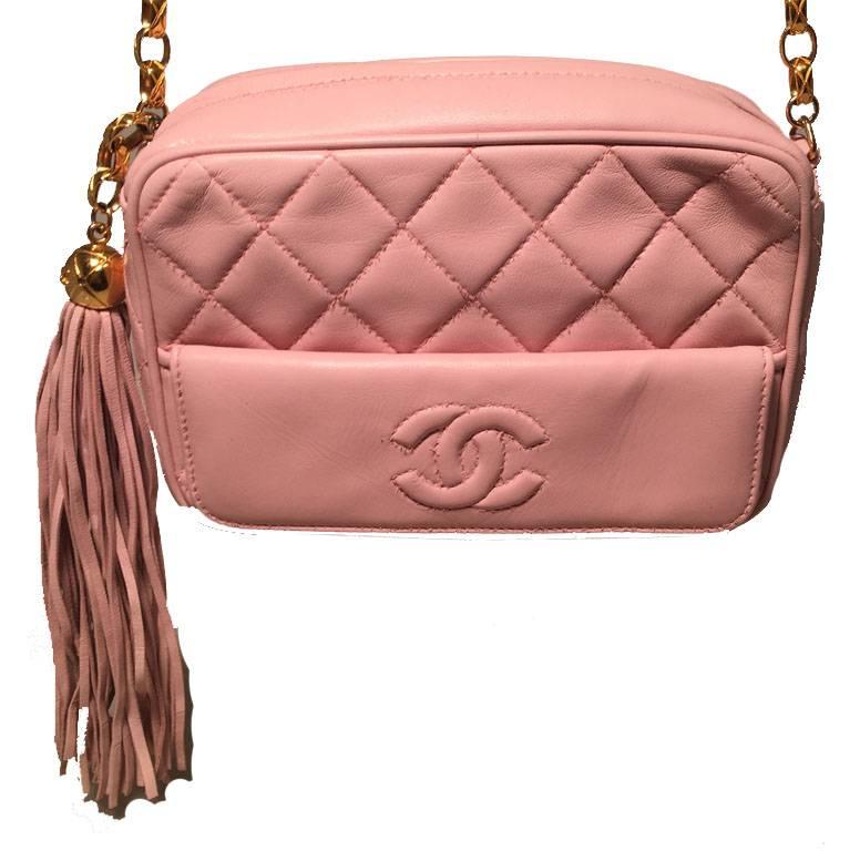ADORABLE Chanel pink leather shoulder bag in very good vintage condition.  Pink quilted leather exterior trimmed with a gold chain link shoulder strap and leather tassel zipper pull. One small flap pocket on front side with quilted CC logo on flap.