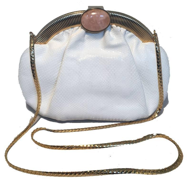 BEAUTIFUL Vintage Judith Leiber white lizard clutch in very good condition.  White lizard leather exterior trimmed with gold hardware and rose quartz stone along top closure.  Lifting closure opens to a tan nylon lined interior that holds 2 slit