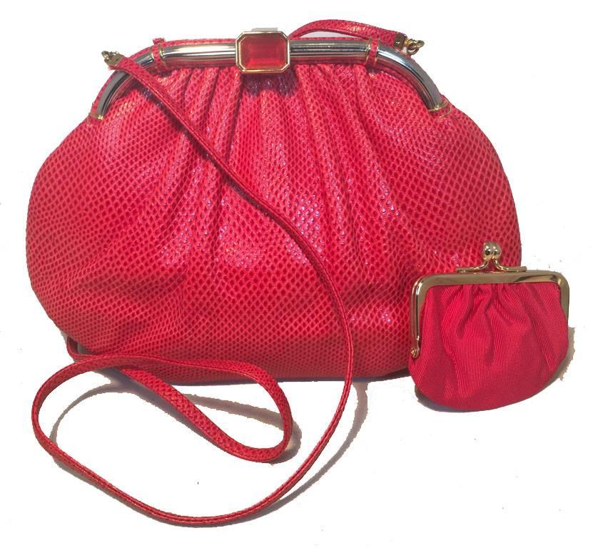 GORGEOUS Judith Leiber red lizard leather clutch in excellent vintage condition.  Red lizard leather exterior trimmed with gold hardware and a red centered glass stone along top closure.  Red nylon lined interior with 2 slit pockets and attached