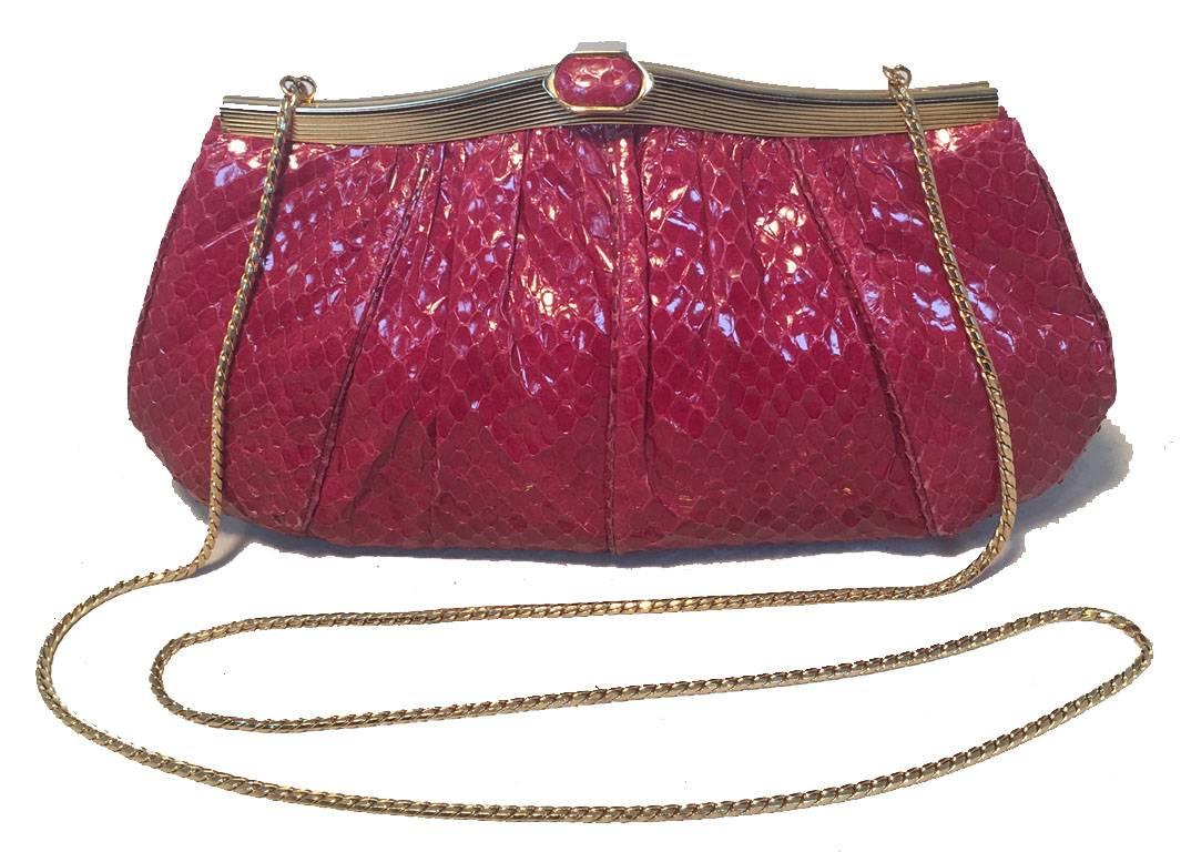 BEAUTIFUL Judith Leiber Maroon snakeskin clutch in very good vintage condition.  Maroon snakeskin exterior trimmed with gold hardware.  Top lifting closure opens to a burgundy satin lined interior that holds 1 side zippered pocket and attached gold