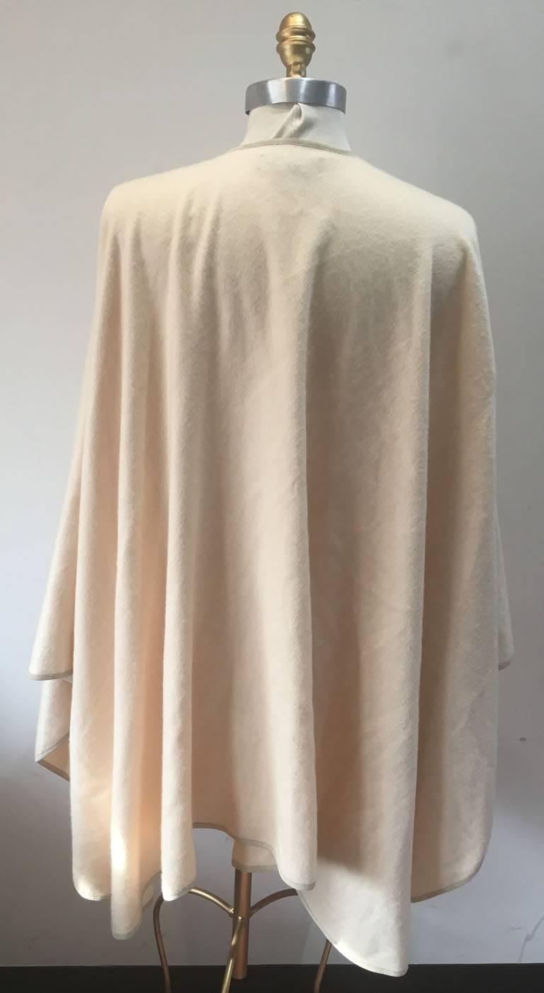 BEAUTIFUL Loro Piano cashmere cape in excellent vintage condition.  Cream cashmere with contrast tan suede leather trim.  Open front.  Unlined. Tag attached. 100% cashmere. Perfect for a variety of occasions.  Can be dressed up or down, paired with