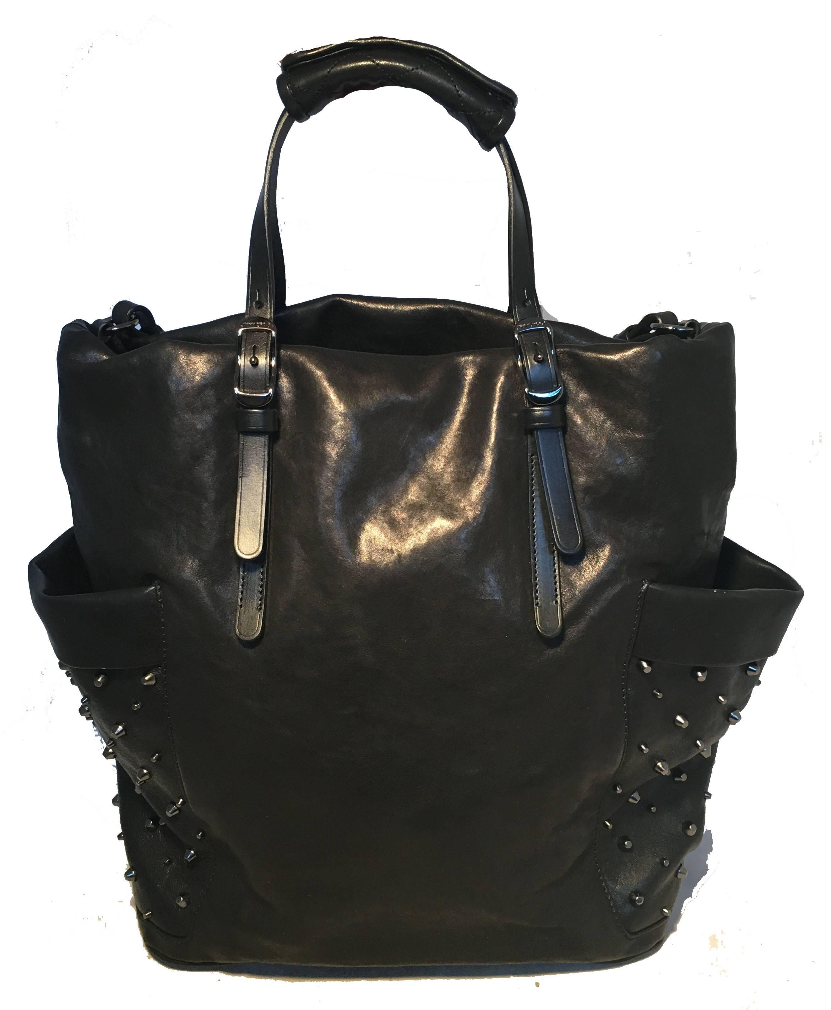 BEAUTIFUL Jimmy Choo black leather studded tote in very good condition.  Black leather body trimmed with gunmetal studs and hardware.  2 exterior side slit pockets for added storage.  Top handles and Shoulder strap to carry as a tote or shoulder