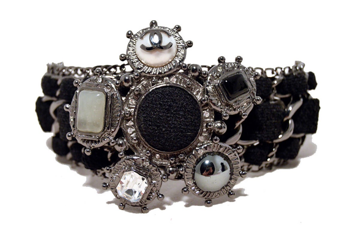 Stunning Rare Authentic Chanel black wool and gunmetal charms bracelet in Mint condition.  Black wool woven through gunmetal hardware with a fabulous left embellishment.  The focal point of this piece features a pearl charm with the signature CC