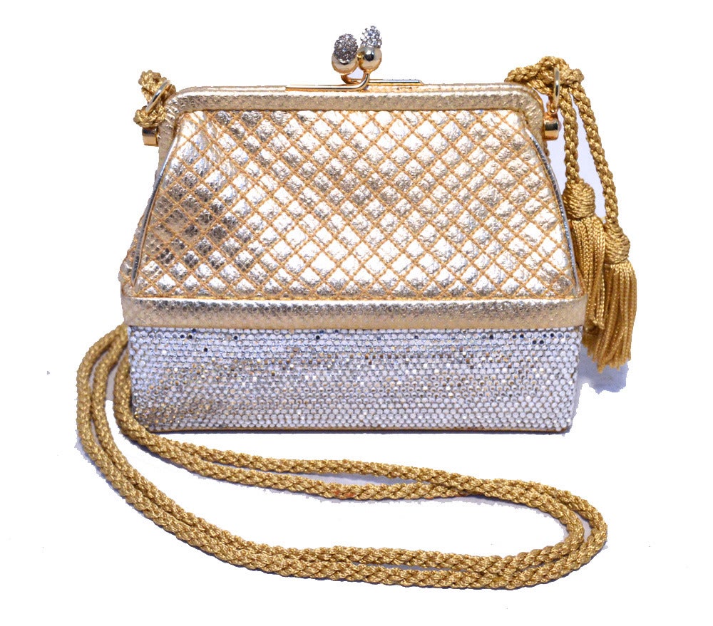 Beautiful JUDITH LEIBER gold leather clear swarovski crystal leather evening bag in excellent condition.  Gold leather exterior with a gold corded shoulder strap with double tassel end details.  The bottom exterior is covered in clear Swarovski