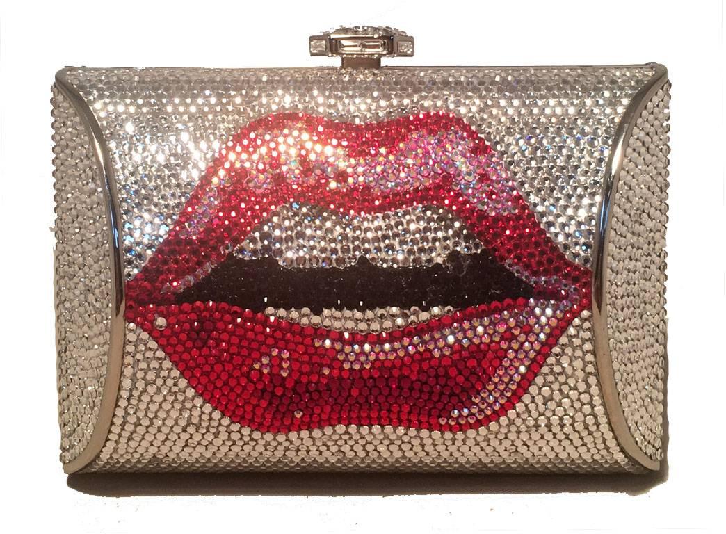 STUNNING NWT Judith Leiber Lip print crystal minaudiere in excellent condition. Silver crystal exterior with red lip print design on both sides. Top button closure opens to a silver leather lined interior that holds an attached hidden chain and