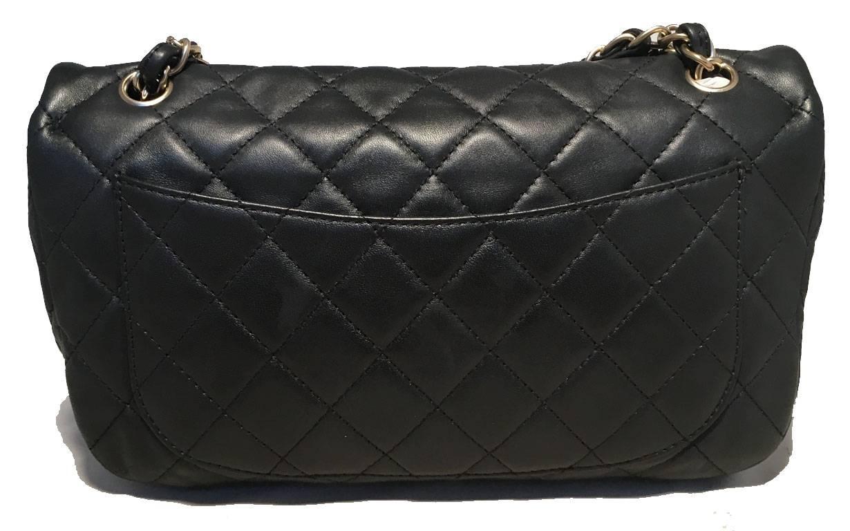 AMAZING Chanel black leather gem logo closure classic flap shoulder bag in excellent condition.  Quilted soft leather exterior trimmed with matte silver hardware, woven chain and leather doubled shoulder strap and gorgeous gem embellished front