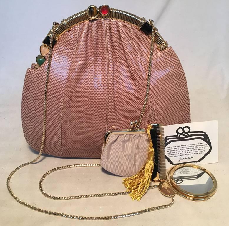 GORGEOUS Judith Leiber tan lizard clutch in excellent condition.  Tan lizard leather exterior trimmed with gold hardware and semi precious stone details along top edge.  Top lift closure opens to a tan nylon lined interior that holds 1 slit and 1