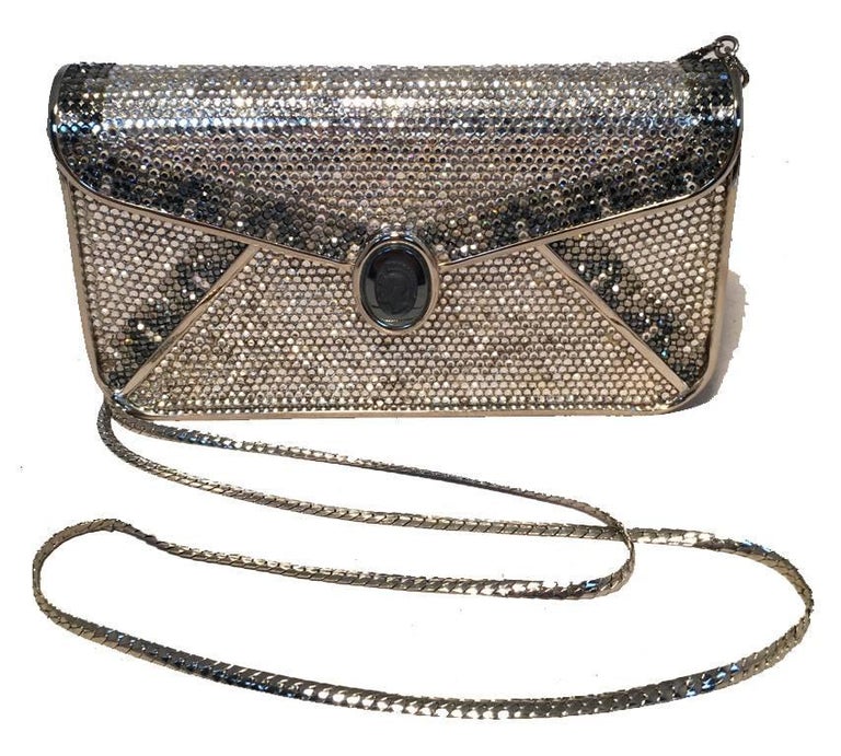 BEAUTIFUL Vintage Judith Leiber Swarovski crystal minaudiere clutch in very good condition. Silver and gray swarovski crystal exterior trimmed with silver hardware and front gray roman soldier cameo detail along front flap closure. Silver leather