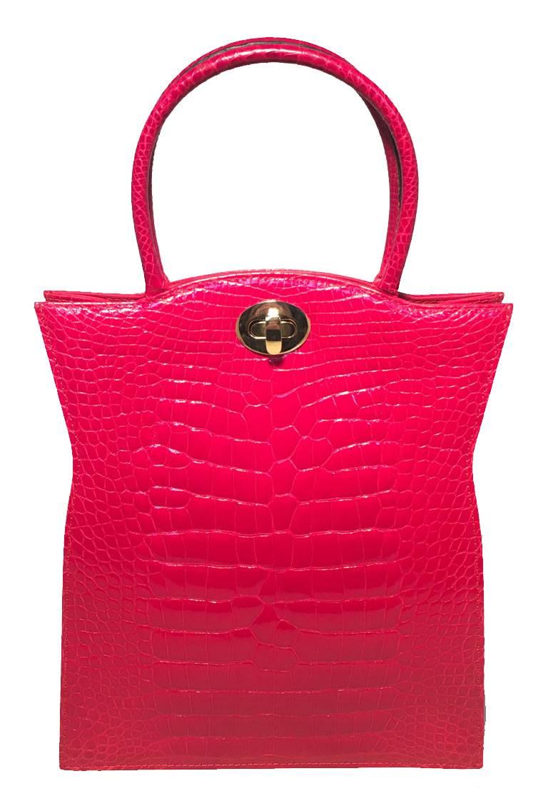 STUNNING Vintage designer red alligator collector handbag in exellent condition.  Red alligator exterior trimmed with gold hardware.  Matching shoulder strap included and easily attaches to convert this piece from hand to shoulder style anytime. 