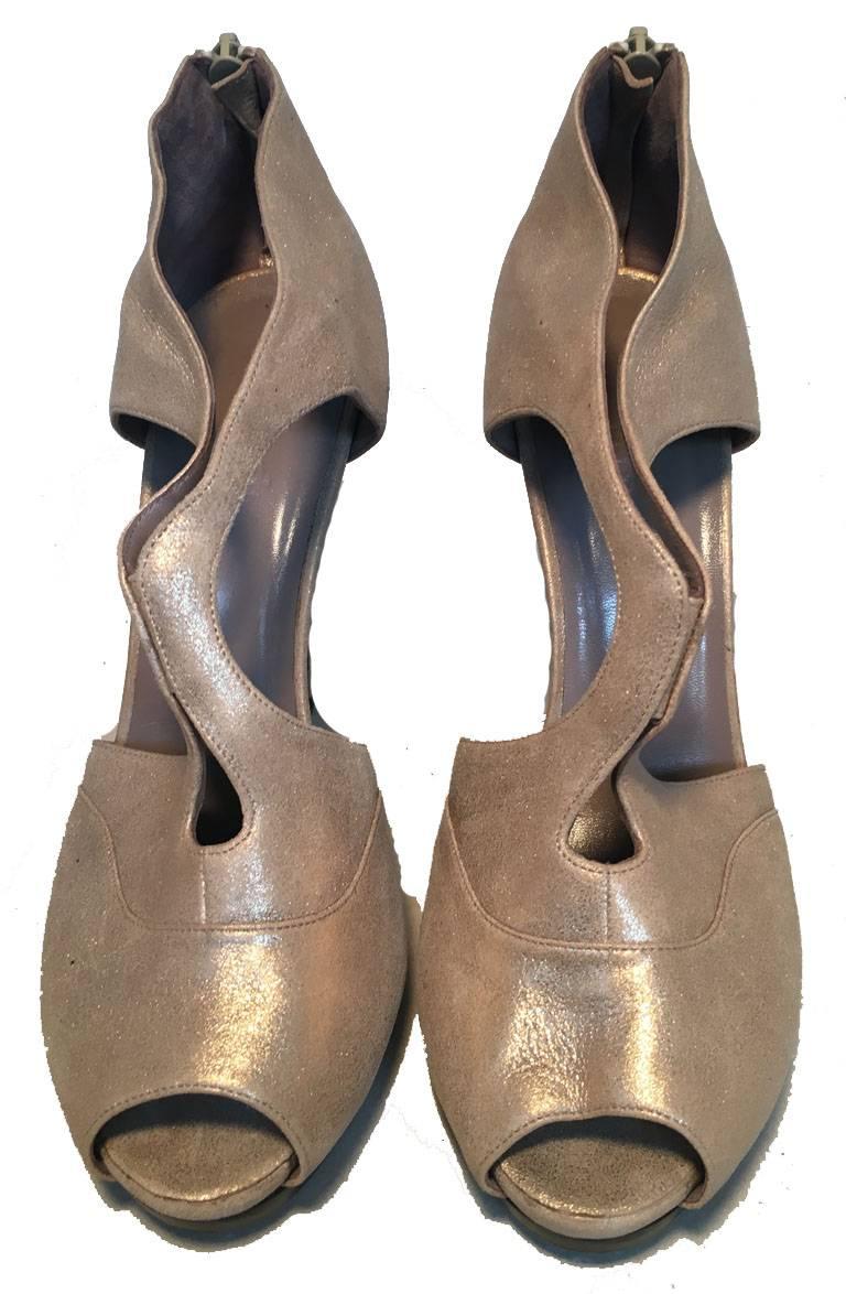 GORGEOUS Hermes shimmery strappy heels in excellent condition.  Golden shimmery leather upper with a unique cut out strappy design.  Zip heel back.  4.5