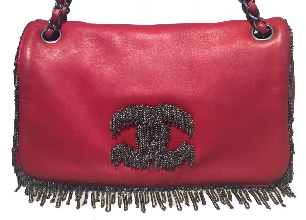 AMAZING Chanel red chain trim classic flap shoulder bag in excellent condition.  Red leather body with gunmetal chain trim around edges and CC logo along front side.  Woven chain and leather shoulder strap.  Single flap snap closure opens to a grey