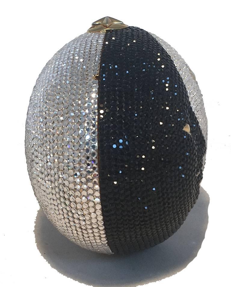BEAUTIFUL Judith Leiber Swarovski Crystal Moon and stars minaudere evening bag in excellent condition.  Black and silver swarovski crystal exterior in Moon and stars design with gold hardware trim.  Button closure opens to a gold leather lined