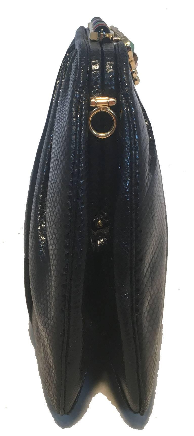 Classic Judith Leiber lizard leather stone top clutch in excellent vintage condition.  Black lizard leather exterior trimmed with gold hardware and round multicolor semi precious stone accents along the top edge.  Lift top closure opens to a black