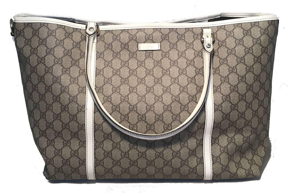 Beautiful Gucci Joy tote in excellent condition.  Monogram canvas exterior trimmed with white patent leather trim and silver hardware.  Top snap closure opens to a brown canvas lined interior that holds one side slit pocket and ample storage space