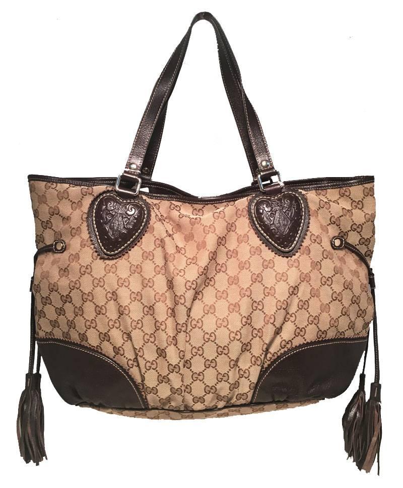 AMAZING Gucci Large Tribeca shoulder bag tote in excellent condition.  Brown monogram canvas exterior trimmed with dark brown leather and gold hardware.
  Unique Tooled leather hear shaped details along each shoulder strap end in addition to 2