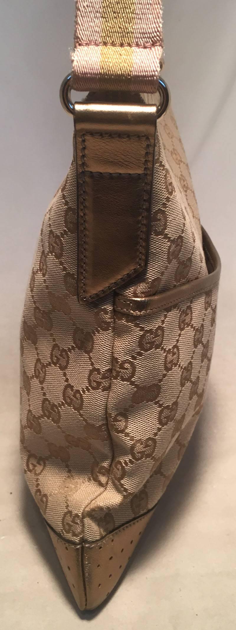 GORGEOUS Gucci medium messenger cross body bag in excellent condition.  Tan monogram canvas exterior trimmed with bronze leather and a pink and bronze striped adjustable shoulder strap.  Front slit pocket with snap closure for additional storage and