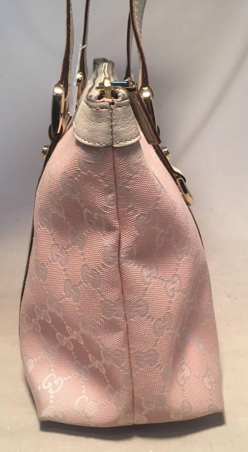 BEAUTIFUL Gucci pink medium abbey tote in very good condition.  Pink monogram canvas trimmed with white leather and gold hardware.  Top zipper closure opens to a pink nylon lined interior that holds 1 zippered and 1 slit side pockets.  No stains,