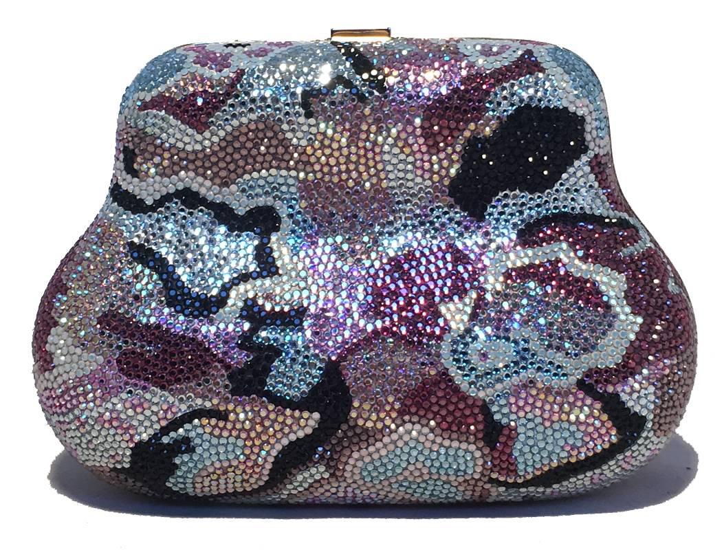 Beautiful Judith Leiber multicolor Swarovski crystal evening bag minaudiere in excellent condition. Swarovski crystal exterior with delicate blue, grey, purple, black and peach crystals in an abstract design throughout the exterior. Top button