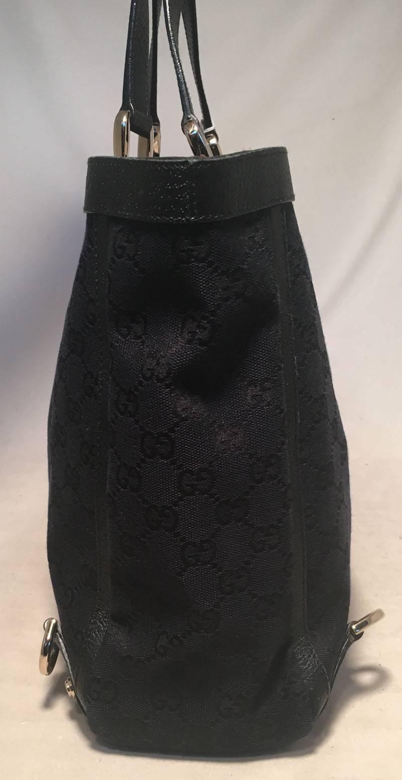 GORGEOUS Gucci Black monogram canvas abbey tote in very good condition.  Black monogram canvas exterior trimmed with black leather and gold hardware.  Top snap closure opens to a black nylon lined interior that holds 1 zipped and 1 slit side