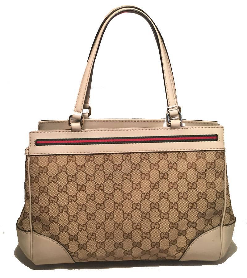 BEAUTIFUL Gucci Mayfair tote in very good condition.  Beige monogram canvas and leather exterior trimmed with gold hardware and signature red and green canvas stripe along top edges.  Double handles and 5 gold feet along bottom.  Top zipper closure